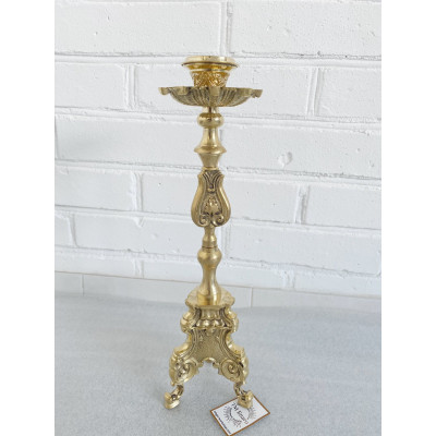 Brass candlestick on the table, 11x39 cm