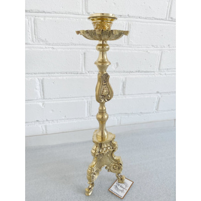 Brass candlestick on the table, 11x39 cm