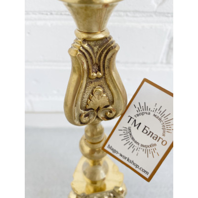 Brass candlestick on the table, 11x39 cm